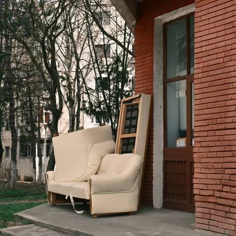 An old armchair left outside a building