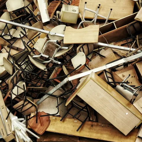 A pile of old wooden chairs