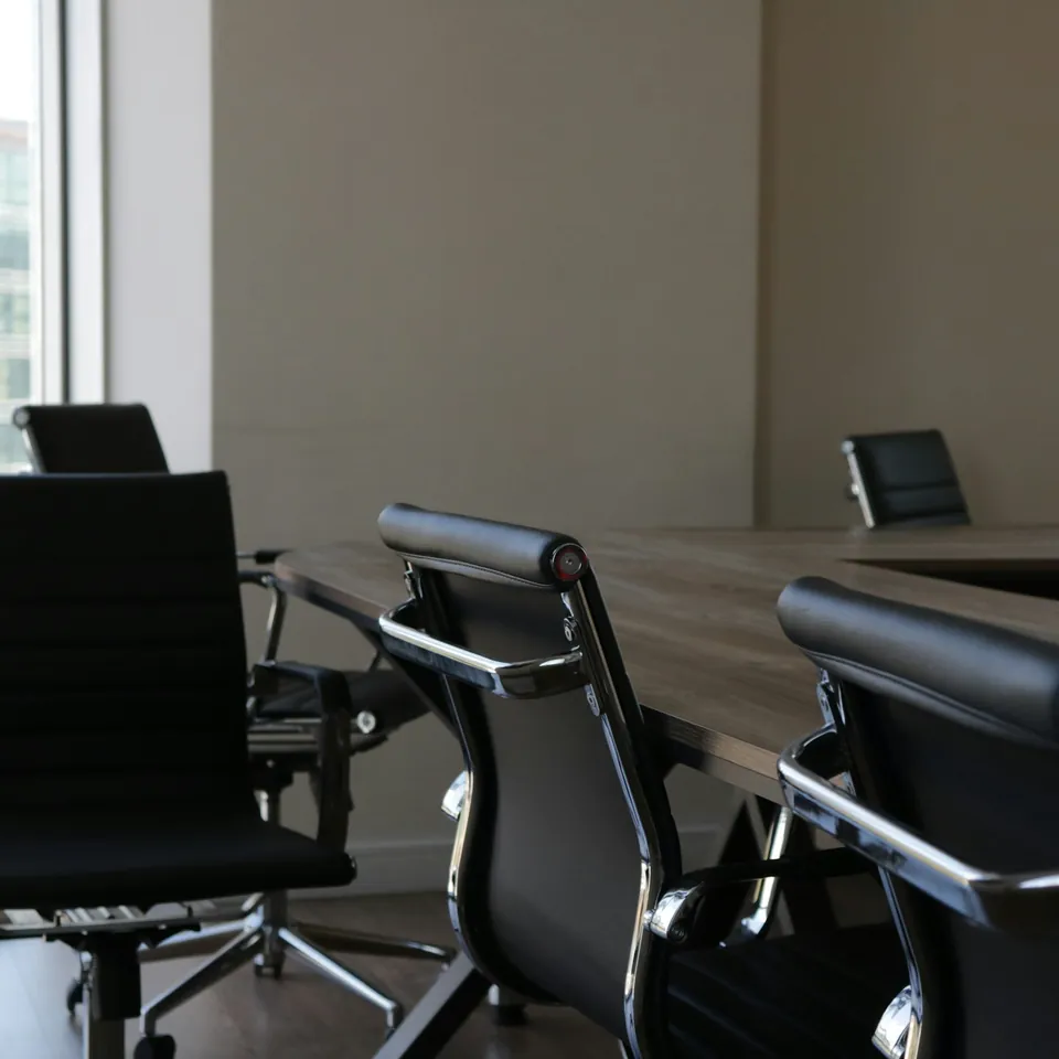 Black office chairs around a meeting table