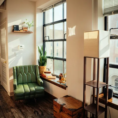 A chair, a side table and a cardboard box in a bright room