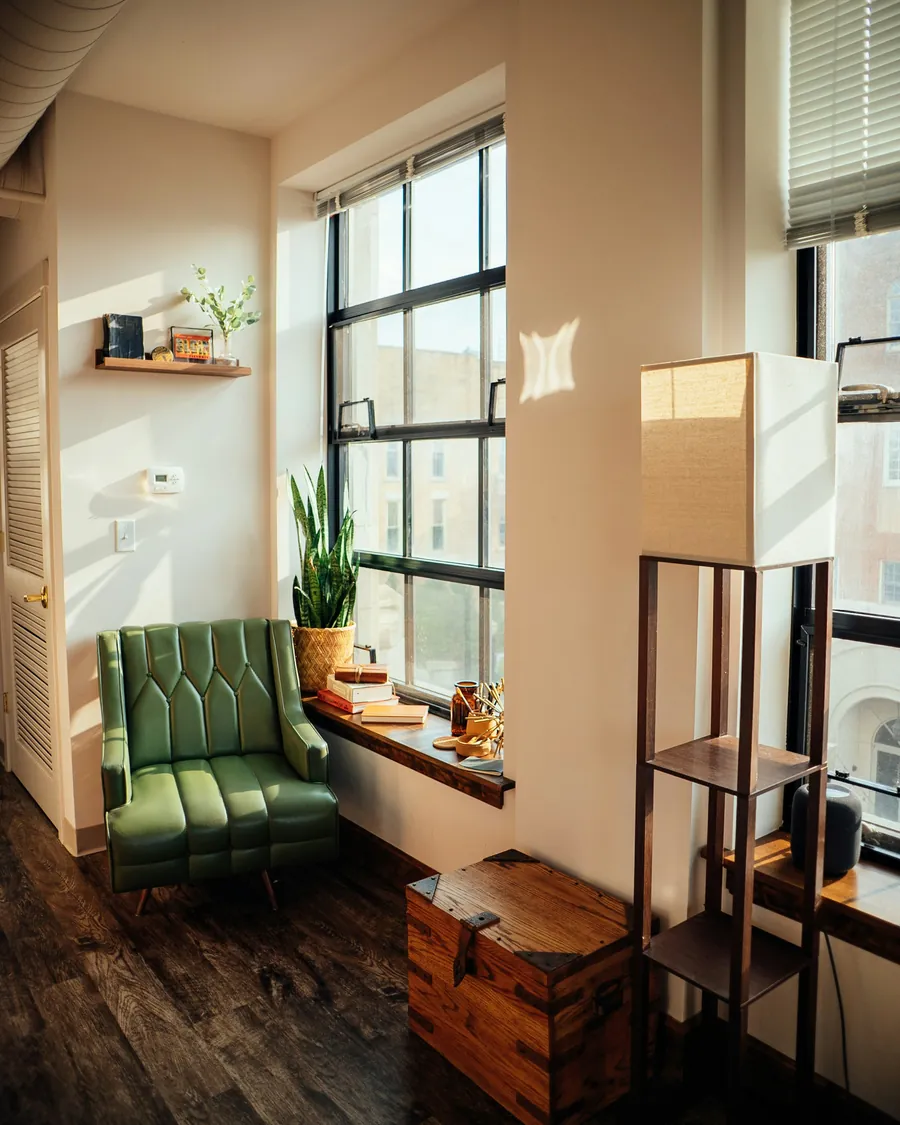 A chair, a side table and a cardboard box in a bright room