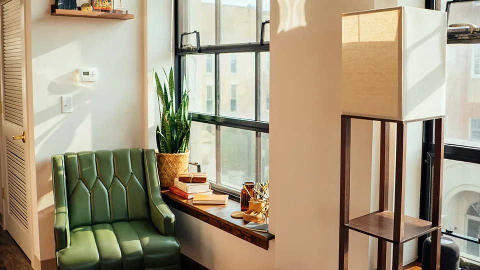 A chair, a side table and a cardboard box in a bright room